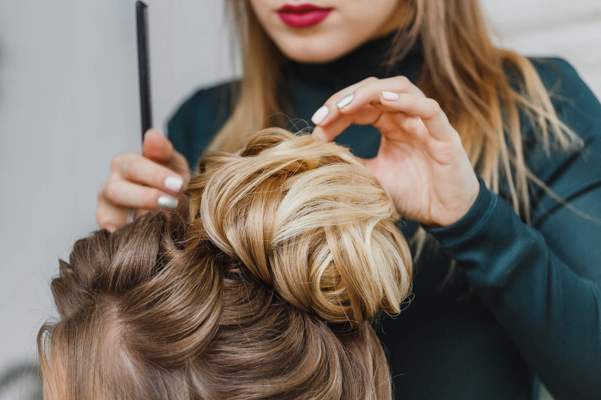 styling hair in messy bun