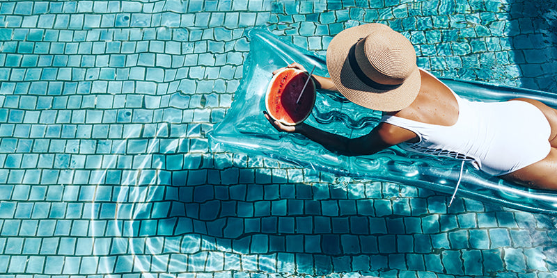 Woman Relaxing In A Swimming Pool